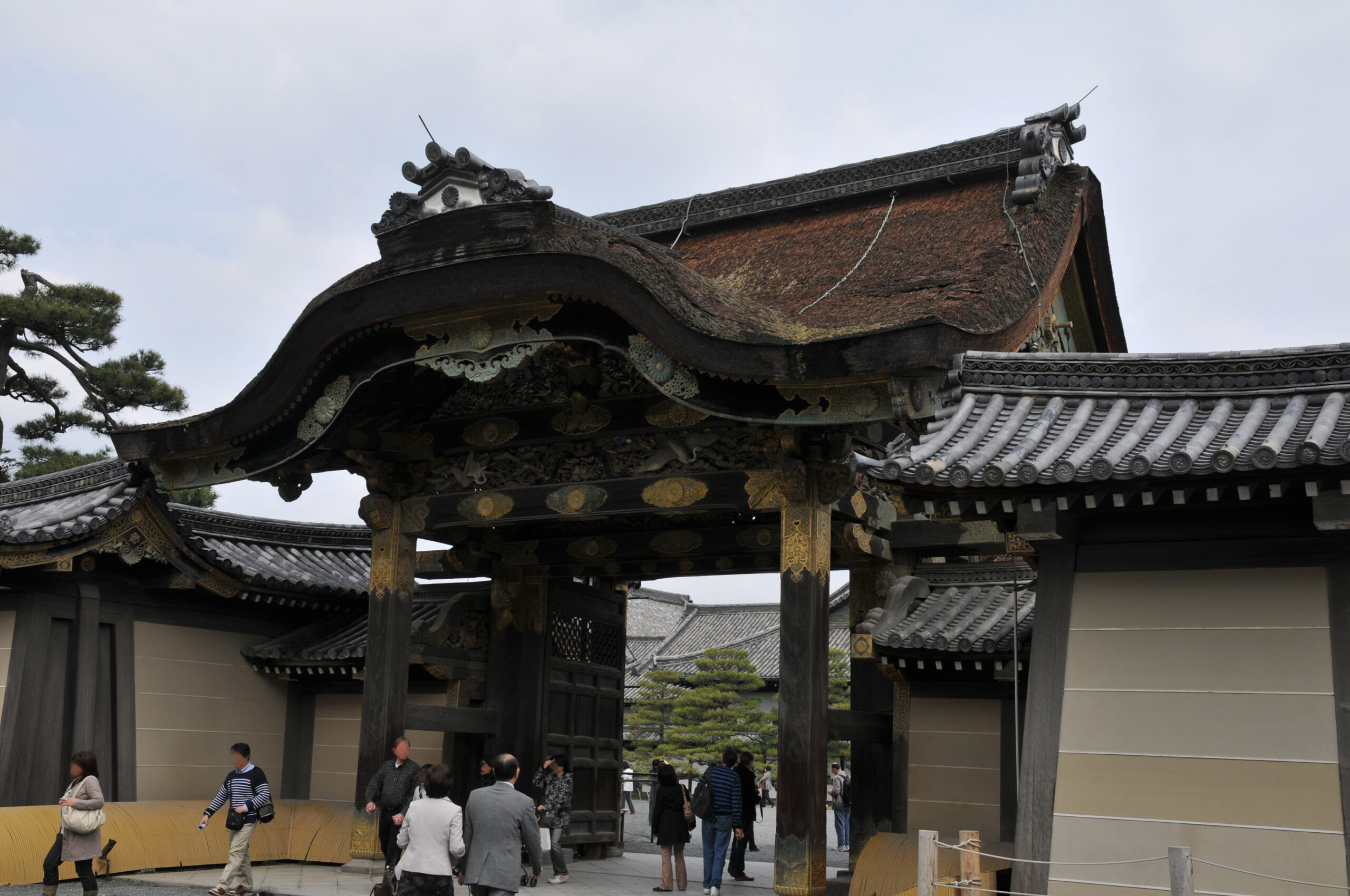 Nijo Castle’s decorated wooden Kara-mon gate with gold details and a curved tiled roof.