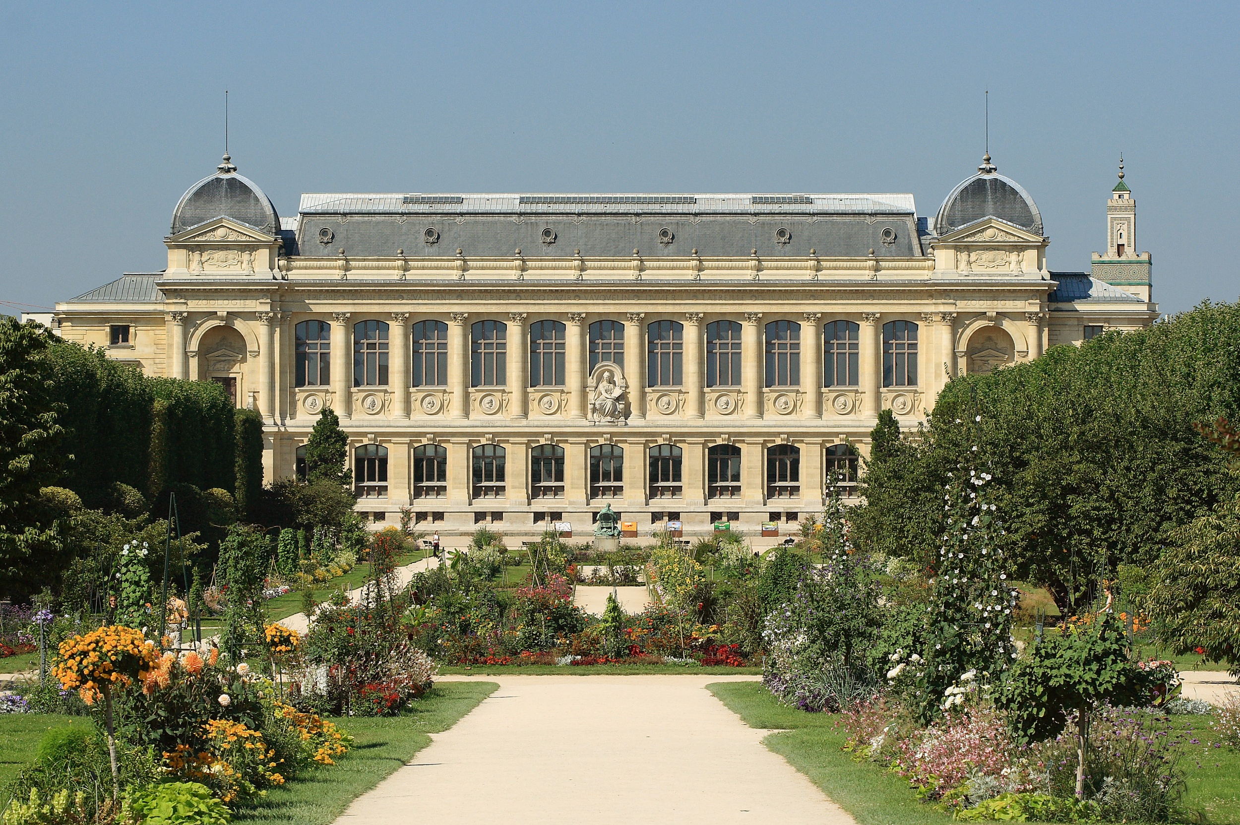 Formal garden beds and paths leading toward the Grande Galerie de l’Évolution in Paris.